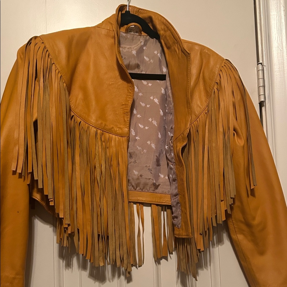 More of a golden yellow, real leather jacket with fringe.